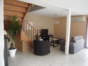 a living room with a couch and a table with a computer at Gîte du séchoir in Bouresse