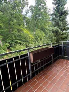 a bench sitting on top of a balcony at Harztastisch Ferienwohnung in Bad Sachsa
