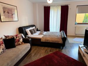 a living room with a bed and a couch at 13StudioBv in Braşov