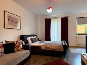 a living room with a bed and a couch at 13StudioBv in Braşov
