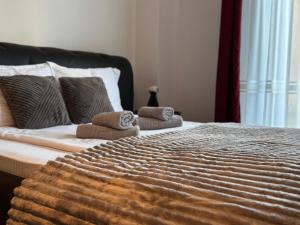 a bedroom with a bed with two towels on it at 13StudioBv in Braşov