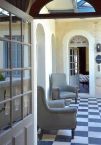 a porch with two chairs and a door at Le Général d'Elbée Hotel & Spa - Teritoria in Noirmoutier-en-l'lle