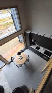 a room with a table and chairs and a window at Deluxe Luosto in Luosto