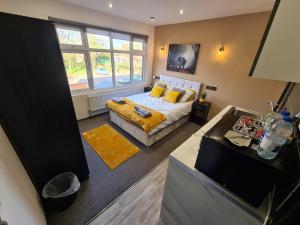 a bedroom with a bed and a window at YPS Studio Rooms in Peterborough