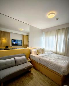 a bedroom with a bed and a couch in it at Prime Zen in Silang +11 photos