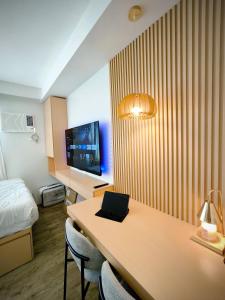 a hotel room with a desk with a laptop on it at Prime Zen in Silang