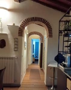 a hallway with an archway in a house at Fienile Paradiso Home Tuscany in Campi Bisenzio