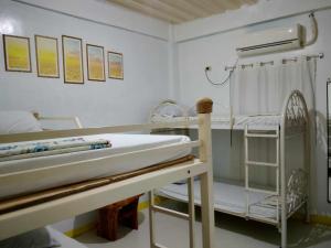 a hospital room with a bed and a sink at Ravara Natividad Homestay in Lucap