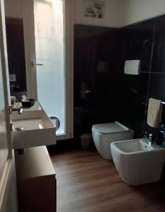 a bathroom with a toilet and a sink and a tub at Fienile Paradiso Home Tuscany in Campi Bisenzio +36 photos