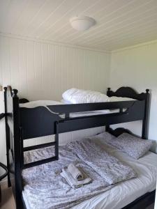 a bedroom with two bunk beds with a hat on them at Apartment Tråstølen ski in ski out in Vossevangen
