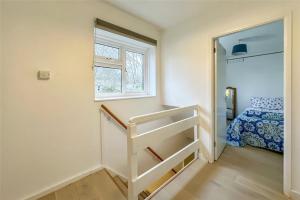 a small room with a staircase leading to a bedroom at Lea River Rooms in Harpenden