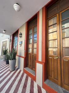 a row of doors on a building with plants at Residencial João Nunes Netto in Laguna