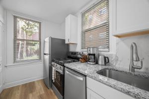 a kitchen with a stainless steel refrigerator and a sink at Pittsburgh Shadyside 1E Bright and Modern Private Bedroom with Shared Bathroom in Pittsburgh