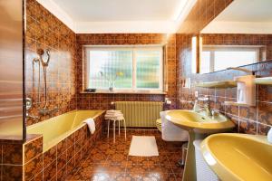 a bathroom with a tub and a sink at Bodensee Bungalow in Immenstaad am Bodensee +53 photos