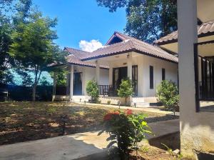 a large white house with a garden in front of it at A-Thip House in Pai +15 photos