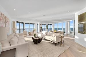 a living room with a white couch and a table at Gulf-front Masterpiece in Naples