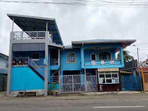 a blue building with a staircase in front of it at Ravara Natividad Homestay in Lucap