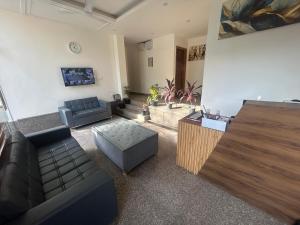 a living room with a couch and a table at RC Stays in Noida