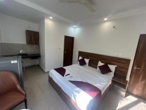 a bedroom with a bed and a desk at RC Stays in Noida
