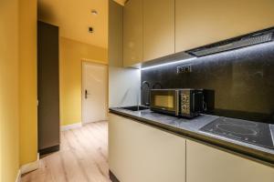 a kitchen with a microwave on top of a counter at AmazINN Collection Madrid Plaza Mayor in Madrid