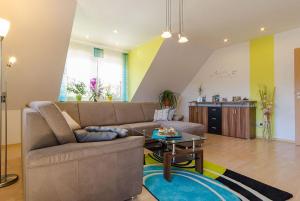 a living room with a couch and a table at Ferienwohnung Lahner in Königsfeld