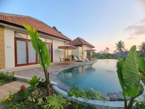 a villa with a swimming pool and a house at The Green Sidemen in Silebeng