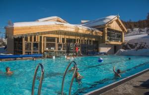 a group of people in a swimming pool in the snow at Appartement au pied des pistes Risoul in Risoul