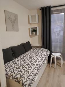 Un pat sau paturi într-o cameră la Appartement au pied des pistes Risoul