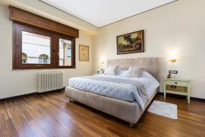a bedroom with a large bed and a window at Reggio Suite in Reggio Calabria