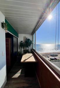 a room with a table and a view of the ocean at Oasis Tropical Sauna Privé Vue Mer & Plage À 100M in Saint-Hilaire-de-Riez