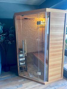a shower with glass doors in a room at Oasis Tropical Sauna Privé Vue Mer & Plage À 100M in Saint-Hilaire-de-Riez