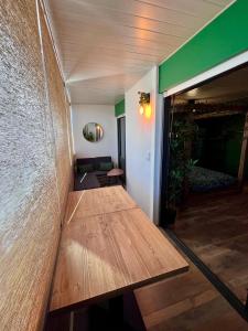 a room with a wooden table and a couch at Oasis Tropical Sauna Privé Vue Mer & Plage À 100M in Saint-Hilaire-de-Riez