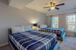 a bedroom with two beds and a ceiling fan at Northridge Retreat in Tannersville