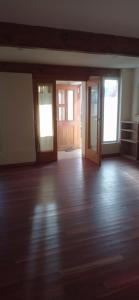 an empty room with wooden floors and doors at Casa del Sol in Trevelin