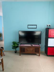a living room with a large flat screen tv at ANA Homestay in Hulu Langat