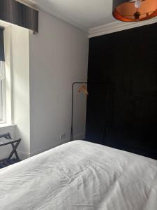 a bedroom with a bed and a black wall at Murray Apartment in Inverness