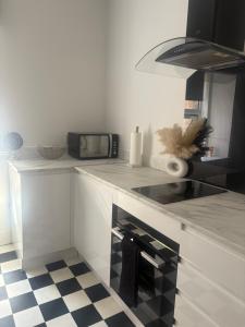 a kitchen with a counter top with a microwave at Murray Apartment in Inverness
