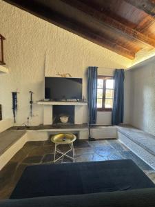 a living room with a tv and a table at Villa Anna in Kalamos