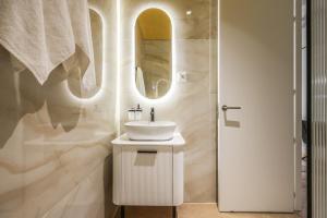 a white bathroom with a sink and a mirror at AmazINN Collection Madrid Plaza Mayor in Madrid +24 photos