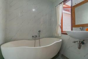 a white bath tub and a sink in a bathroom at Pondok di Uma Villa Ubud in Ubud +26 photos