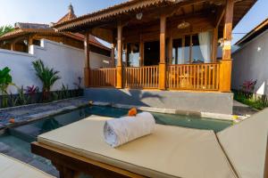 a roll of toilet paper sitting on a table in front of a house at Pondok di Uma Villa Ubud in Ubud