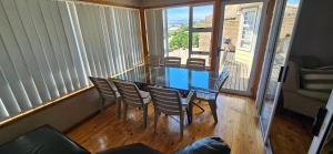 a dining room with a glass table and chairs at Mountain View in Klein Brak Rivier