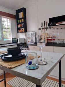 une cuisine avec une table avec un verre de vin dessus dans l'établissement Karen Cottage with Private Garden WiFi, à Nairobi