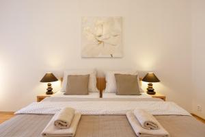 a bedroom with a large bed with two lamps at St. Hubert House in Prague