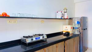 a kitchen with a counter with a stove on it at 3bhk Villa calangute in Calangute