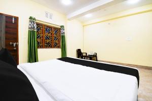 a bedroom with a white bed and a door at Hotel O HIGHWAY STAY IN in Bandha Chhada +33 photos