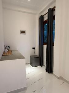 a white room with a table and a window at The Green Loft Rooms in Ahangama