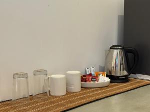 a counter with a coffee maker and cups on it at The Green Loft Rooms in Ahangama +9 photos