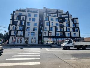 a white truck parked in front of a large building at La Matei in Bistriţa
