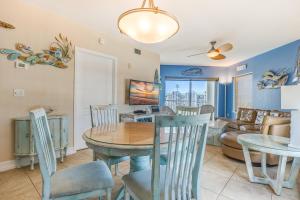 a dining room and living room with a table and chairs at August Beach Getaway Specials Book & Save! in St. Pete Beach